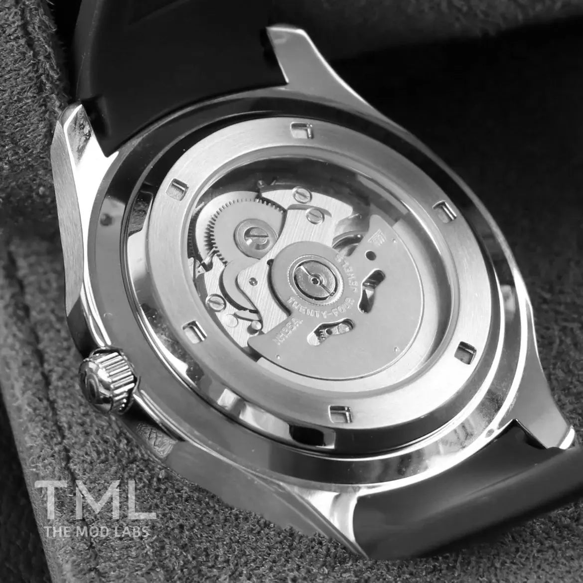 Close-up of a watch's mechanical components with 'TML The Mod Labs' branding.