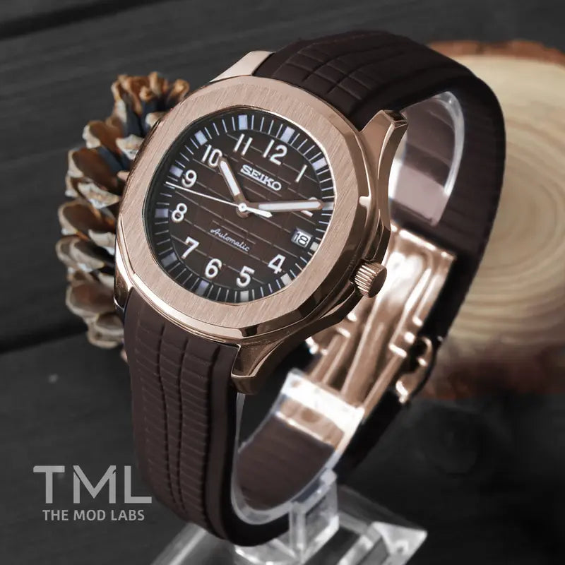 Seiko mod watch the rose gold seikonaut seiko mod with brown strap on a wooden surface, featuring 'TML The Mod Labs' branding.