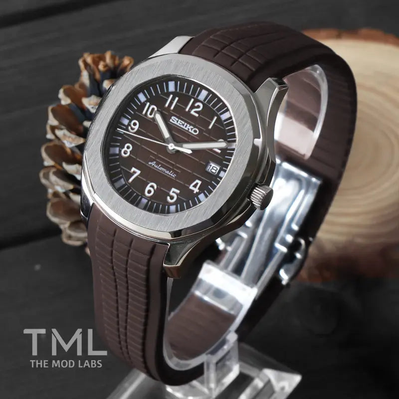 seiko mod aqua_naut_brown  with brown strap on a wooden surface, branded 'TML The Mod Labs'.