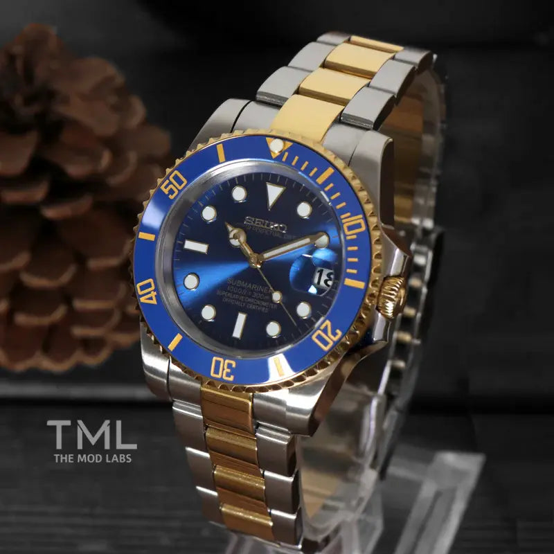 seiko mod watch gold and silver and blue submariner on a dark background the mod labs